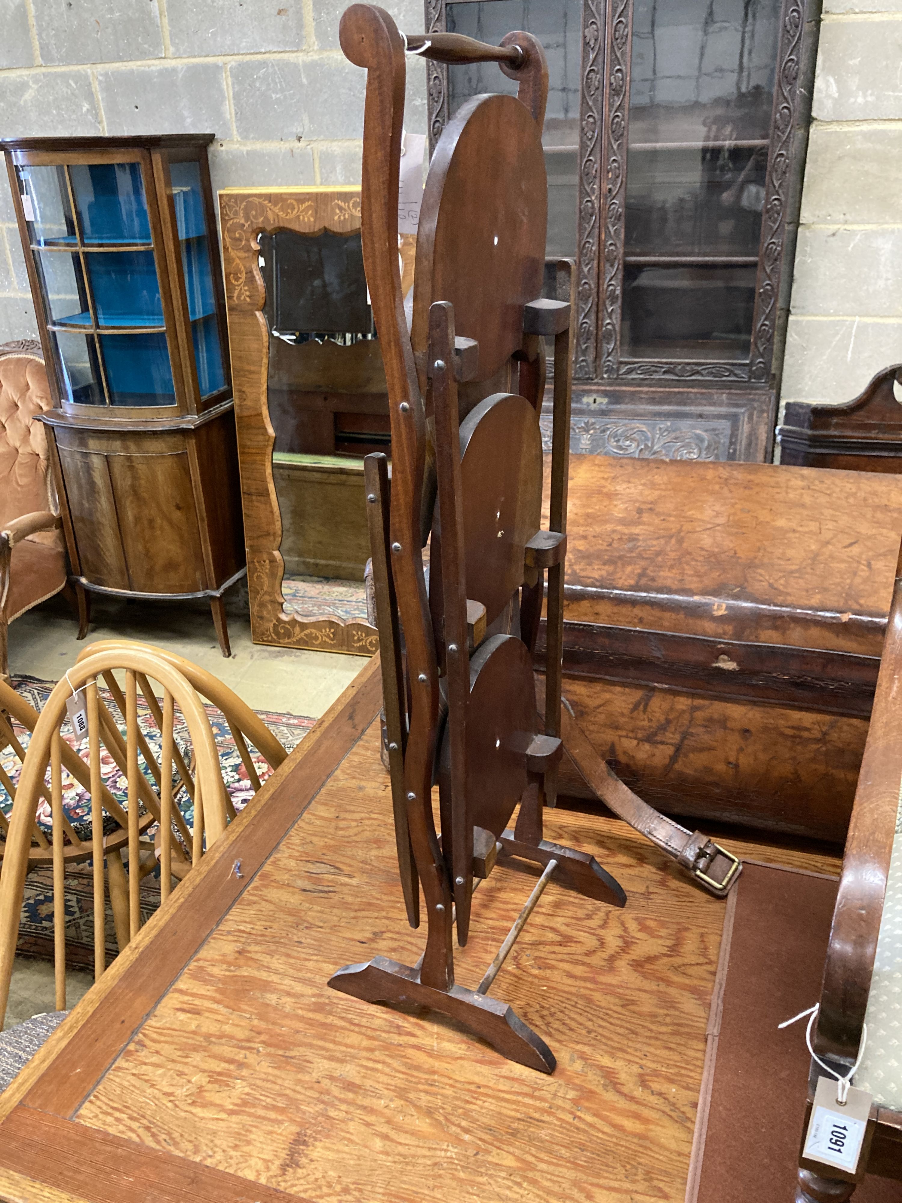 An Edwardian mahogany folding cake stand together with a mahogany toilet mirror